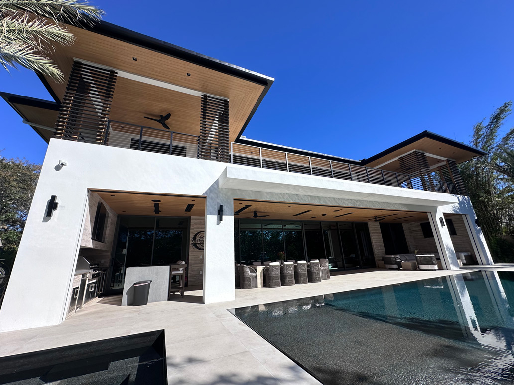 A large white house with a pool in the middle of it